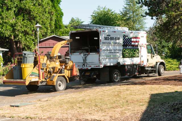 Chip truck and chipper at a home